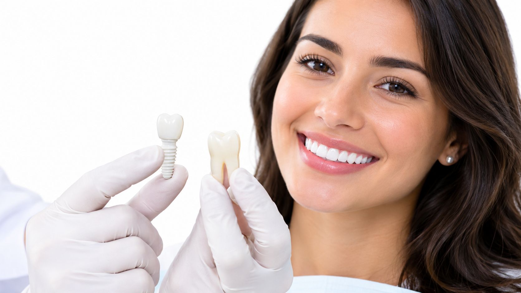 A smiling patient looks on as a dentist compares a zirconia dental implant to a natural tooth model.