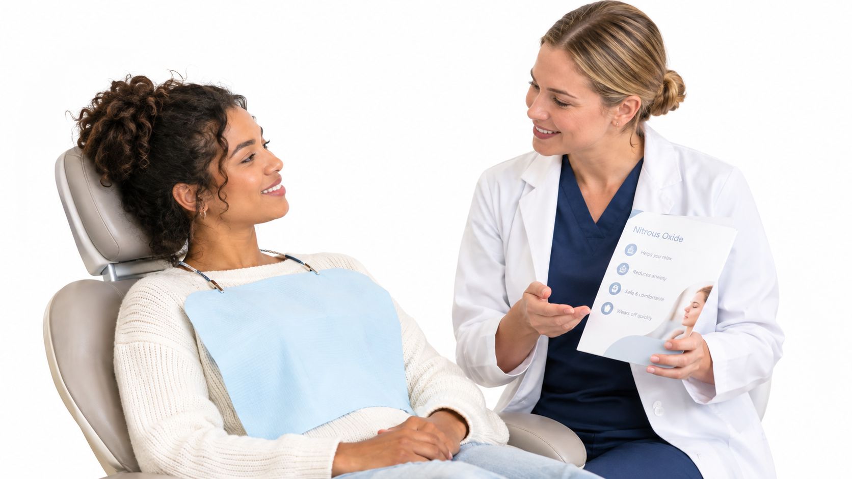 A friendly female dentist explains the benefits of nitrous oxide to a calm patient in a chair.