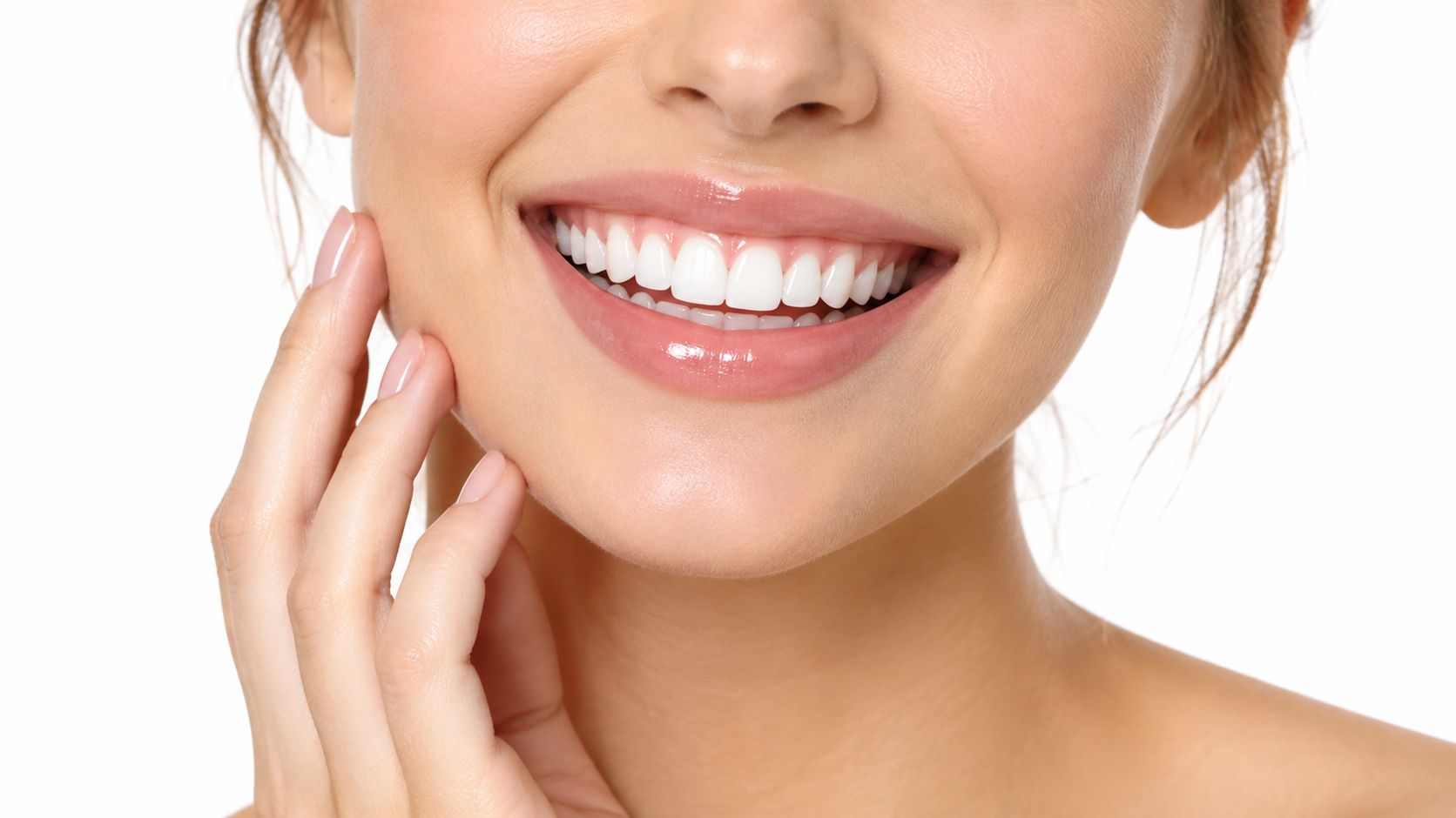 A close-up of a woman with a beautiful smile showcasing healthy white teeth and gums.